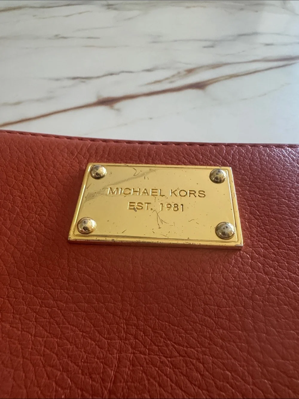 Michael Kors Brick Red Leather Zip-Around Wallet with Gold Plaque